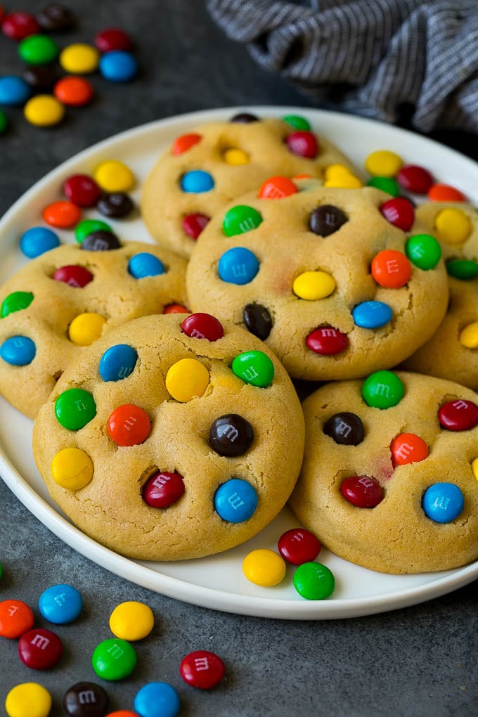 A plate of M&M cookies, garnished with extra candy.