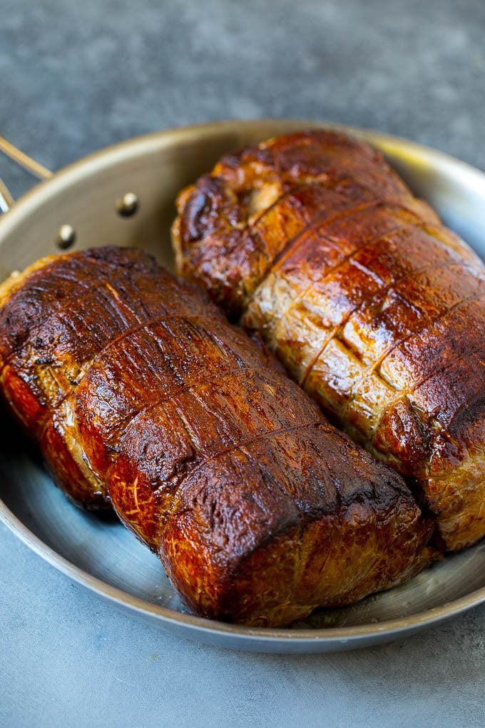 Seared tenderloin roasts in a pan.