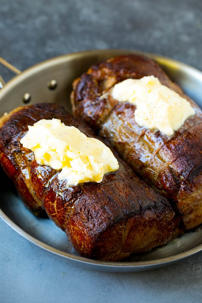 Beef roasts topped with garlic butter.