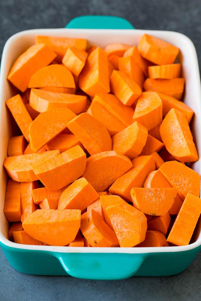 Sliced sweet potatoes in a baking dish.