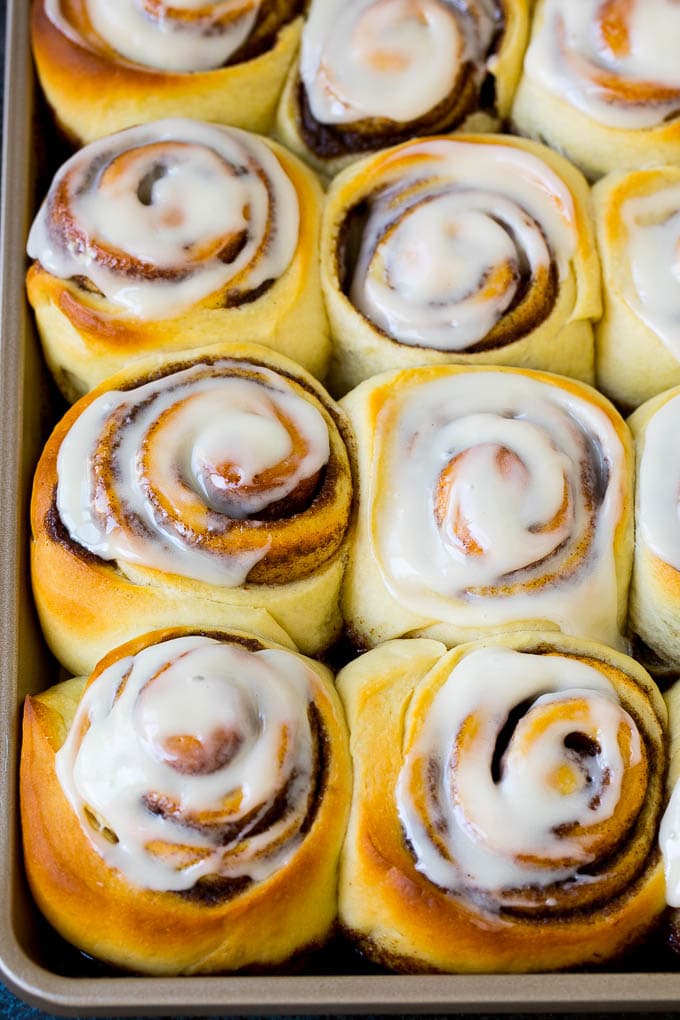 A tray of frosted cinnamon rolls.