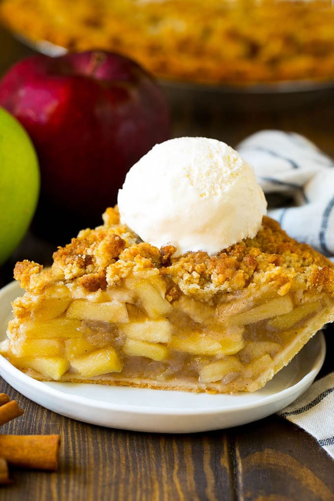 A slice of Dutch apple pie topped with ice cream.