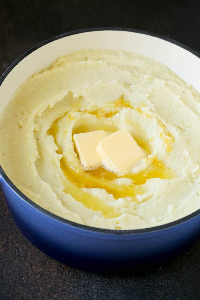 Mashed potatoes with melted butter on top.