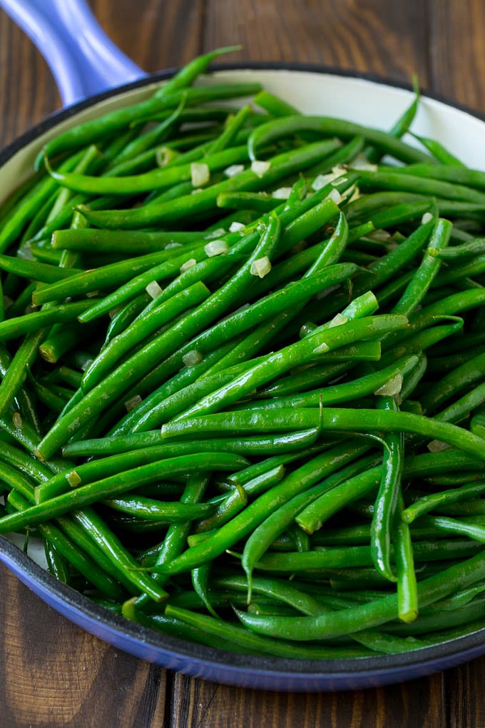 Cooked green beans tossed with diced onion.