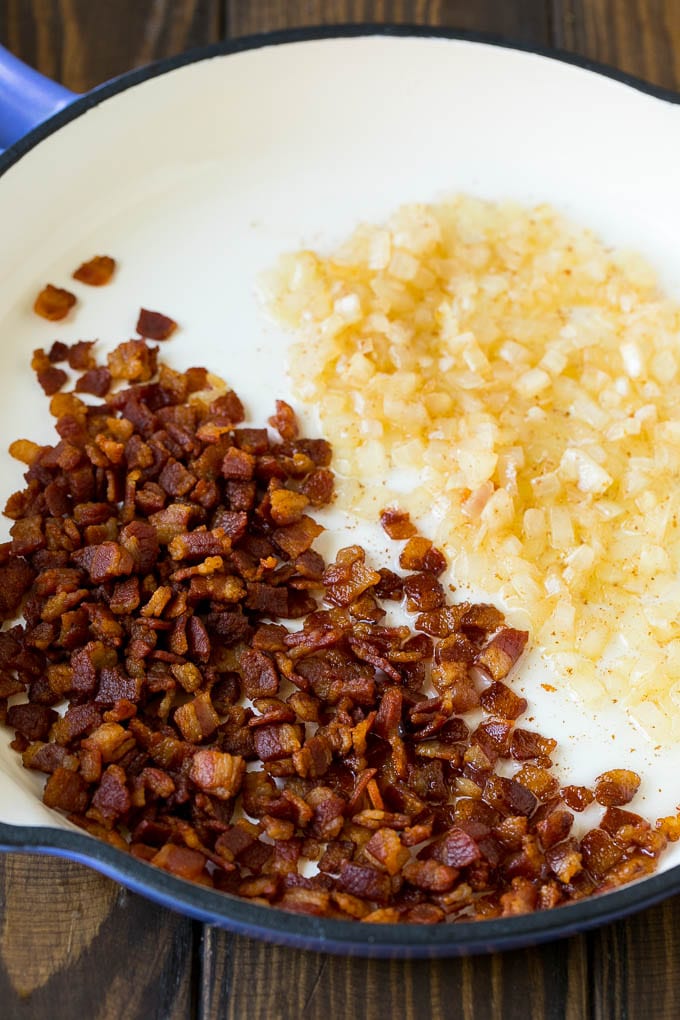 Cooked bacon and sauteed onions in a skillet.