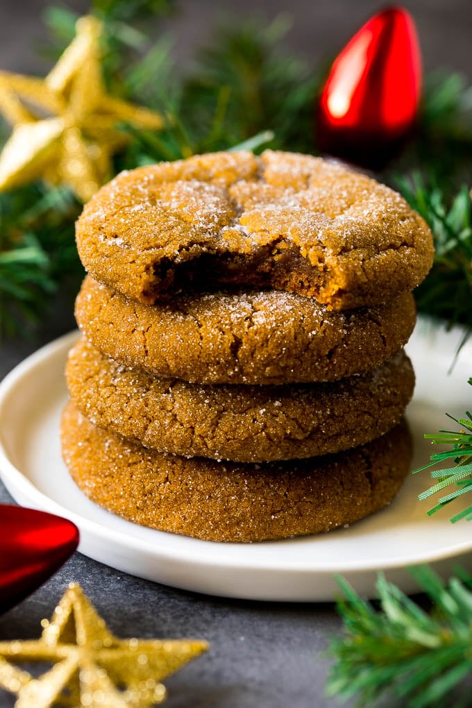 A stack of molasses cookies with a bite taken out of one.