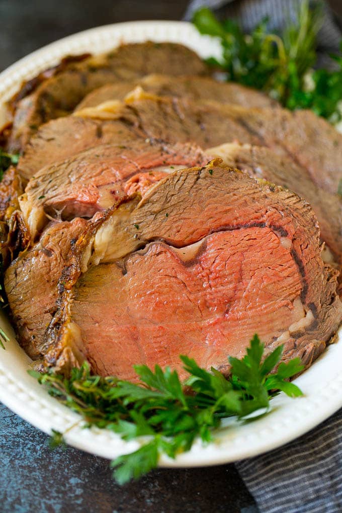 Sliced slow roasted prime beef on a serving platter.