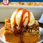 This pumpkin dump cake is a creamy pumpkin pie filling topped with a decadent pecan butter cake.