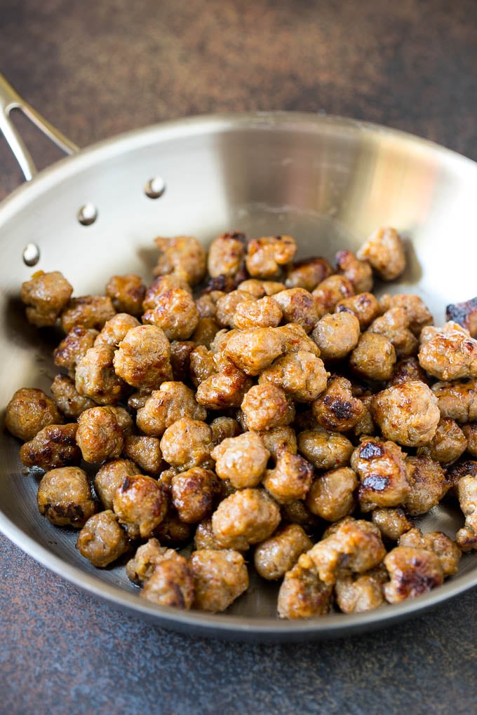 Cooked sausage in a skillet.