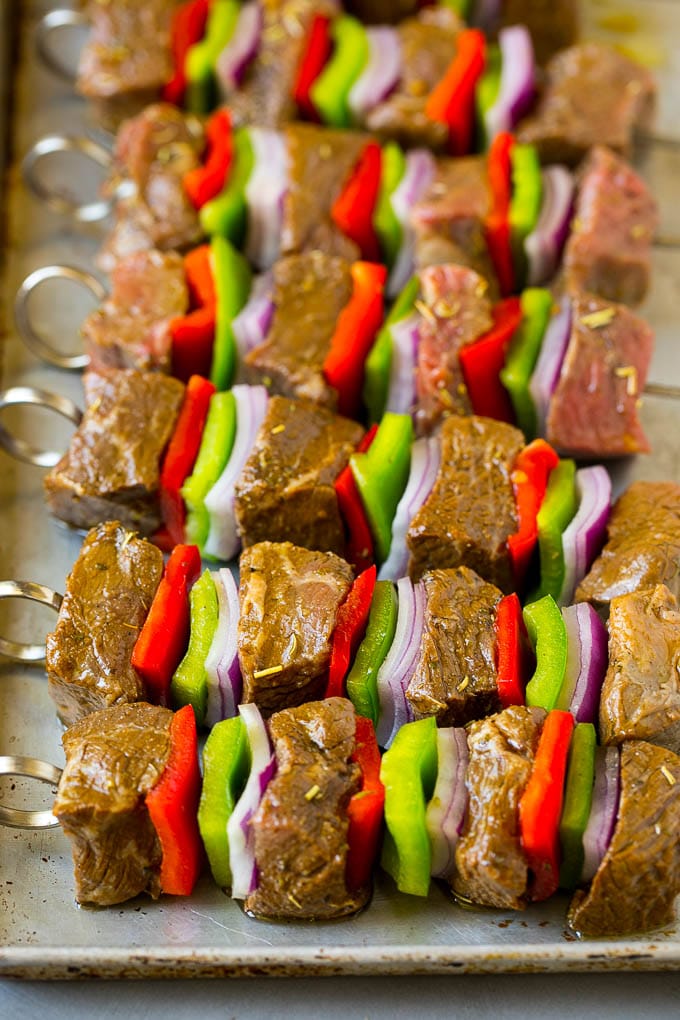 Raw beef skewered with peppers and onions.