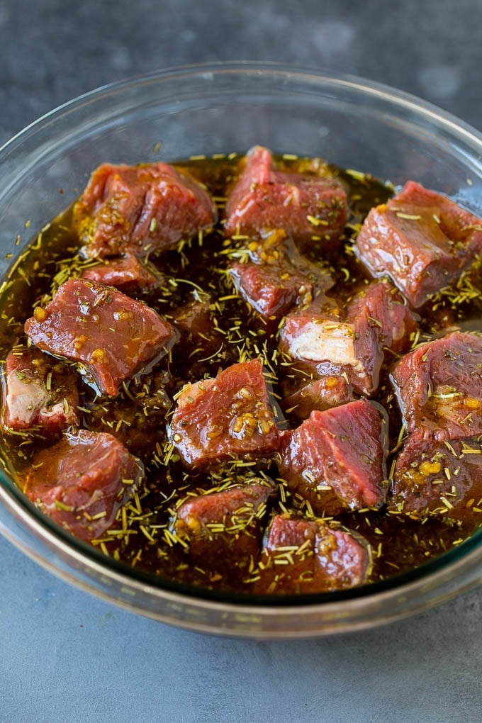 Steak cubes in a bowl of marinade.