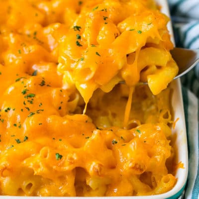 A spoon serving up a portion of Southern mac and cheese.