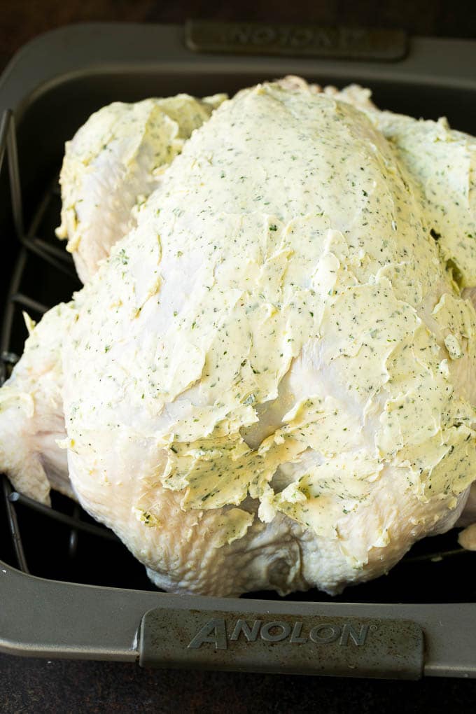A turkey coated in herb butter.