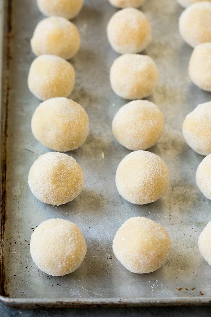 Thumbprint Cookies | Sugar Cookies #cookies #baking #christmas #dessert #dinneratthezoo Balls of cookie dough rolled in sugar.
