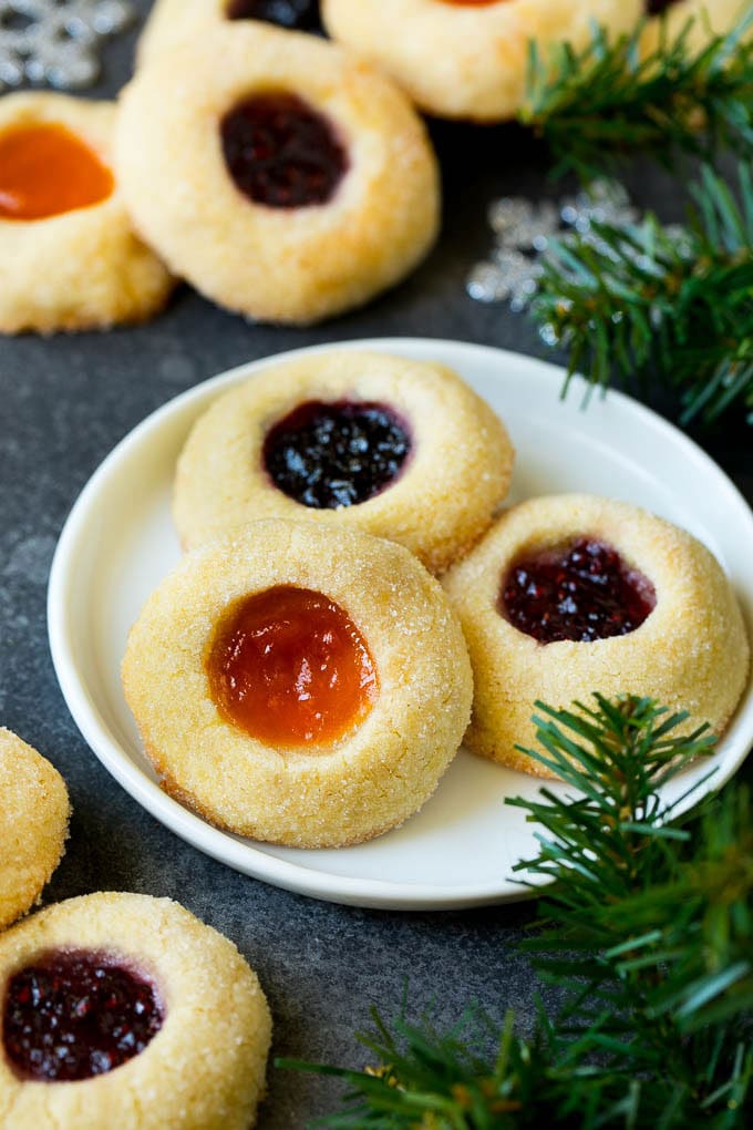 A plate of jam filled thumbprint cookies.