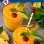 This tropical smoothie recipe is a blend of mango, pineapple, banana and coconut milk, all mixed together to create a creamy and refreshing drink.