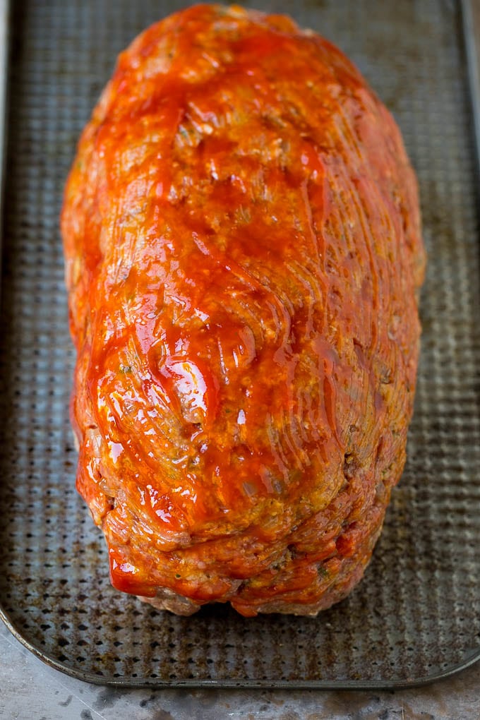 Ground beef shaped into a loaf and coated in ketchup.