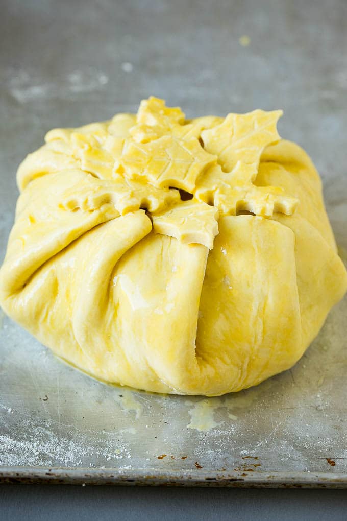 Brie wrapped in puff pastry and topped with egg wash.