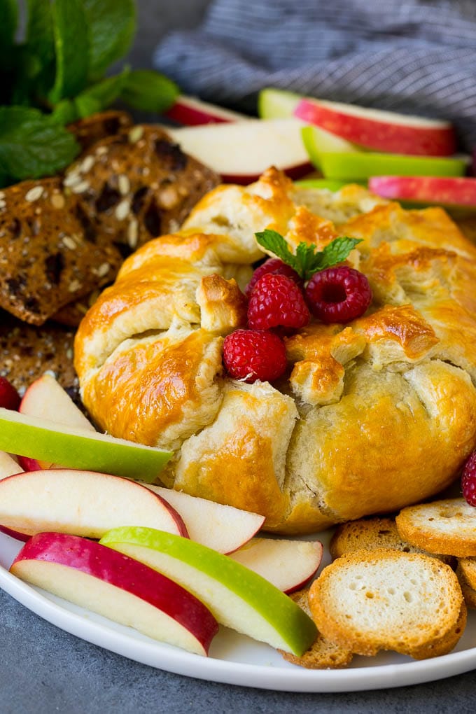 Brie wrapped in puff pastry, served with apples and crackers.