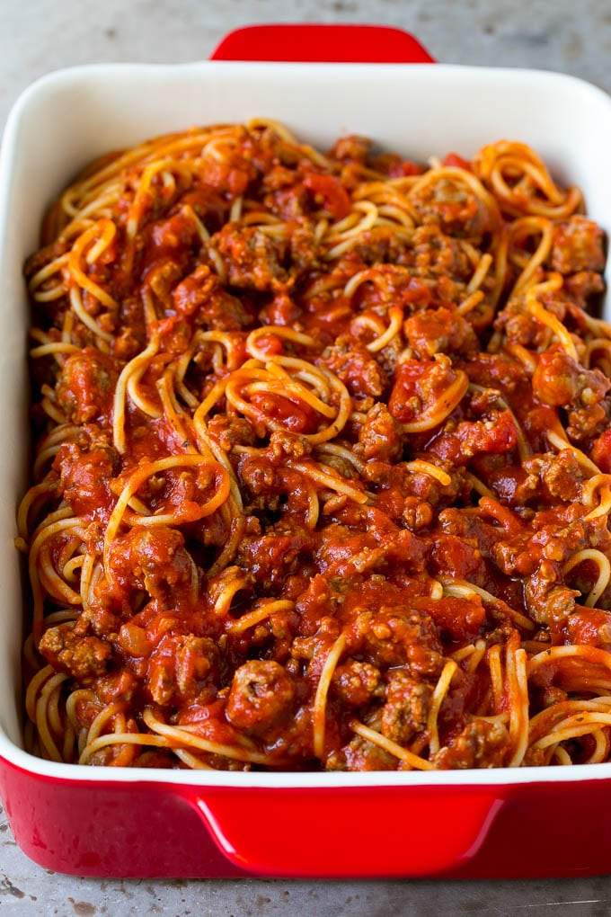 Spaghetti tossed with meat sauce in a baking dish.