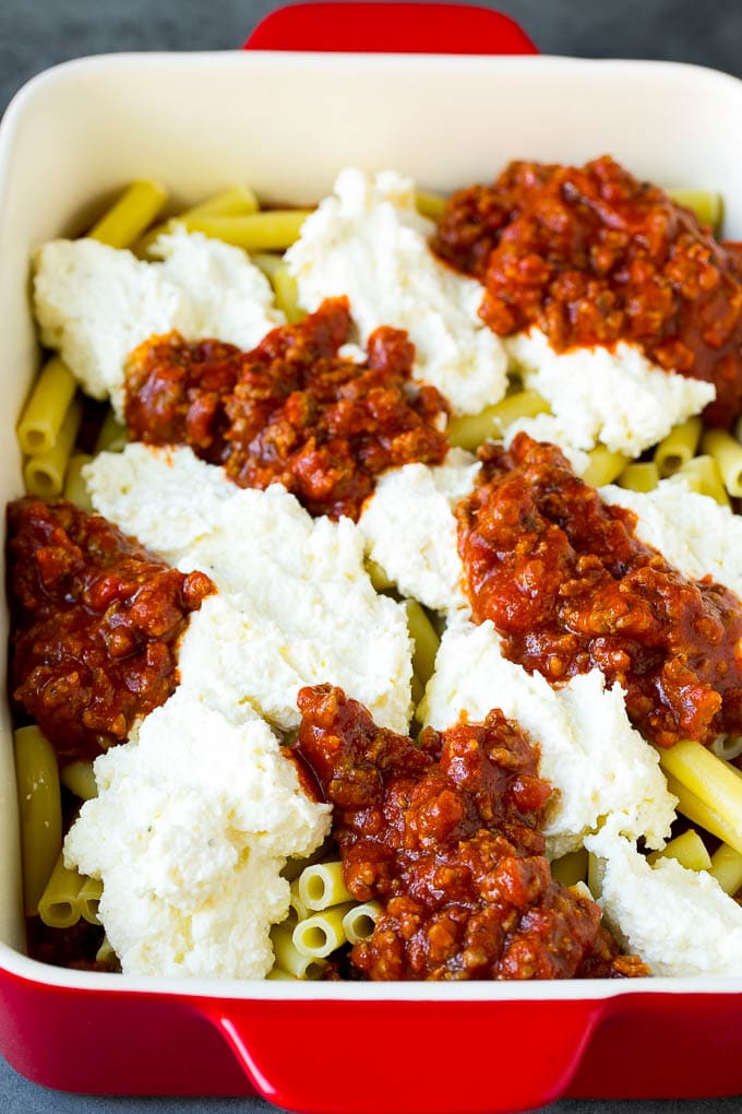 Pasta with dollops of pasta sauce and ricotta cheese.