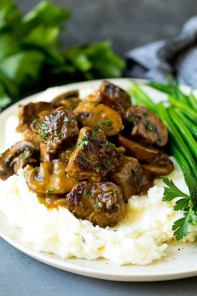 Beef tips served over mashed potatoes with green beans.
