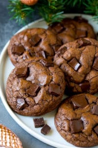Brownie cookies on a serving plate, topped with chocolate chunks.