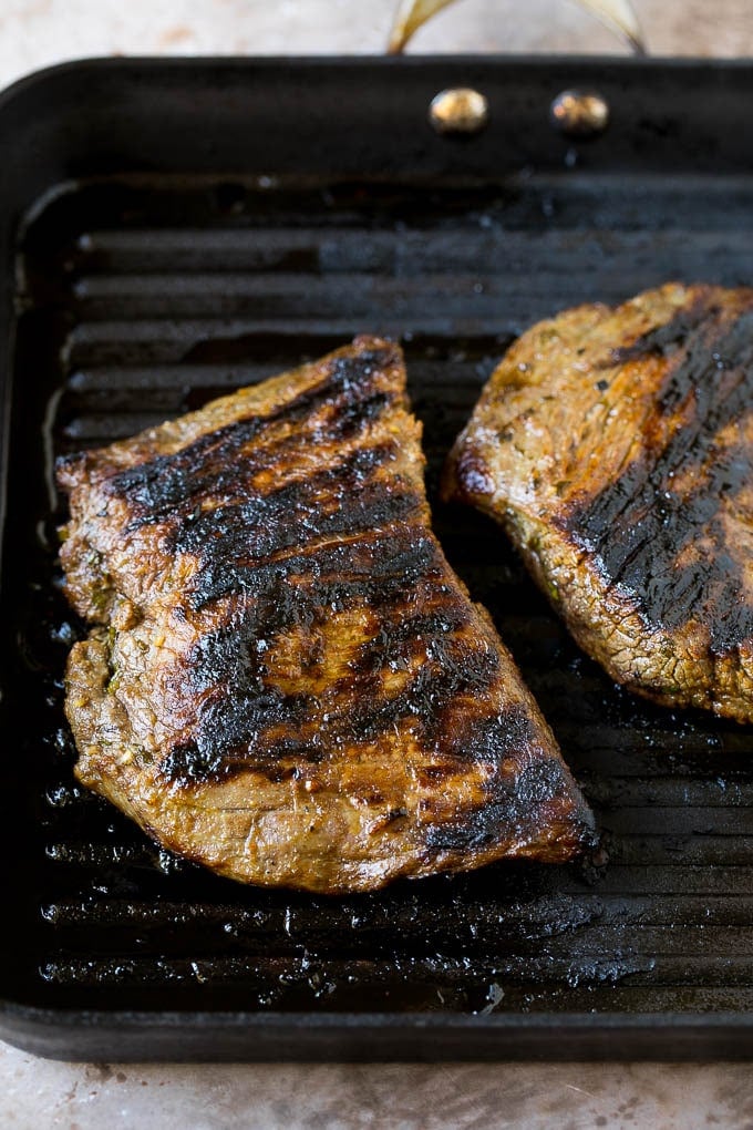Grilled carne asada steak in a pan.