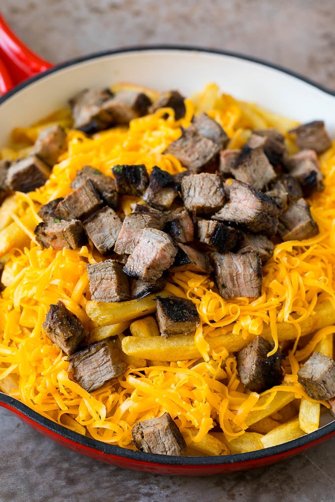 French fries topped with shredded cheese and diced steak.