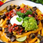 Carne asada fries topped with melted cheese, steak, salsa and guacamole.