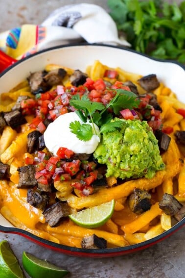 Carne asada fries topped with melted cheese, steak, salsa and guacamole.
