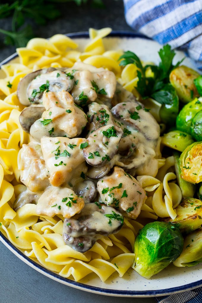 Chicken stroganoff over egg noodles with brussels sprouts on the side.