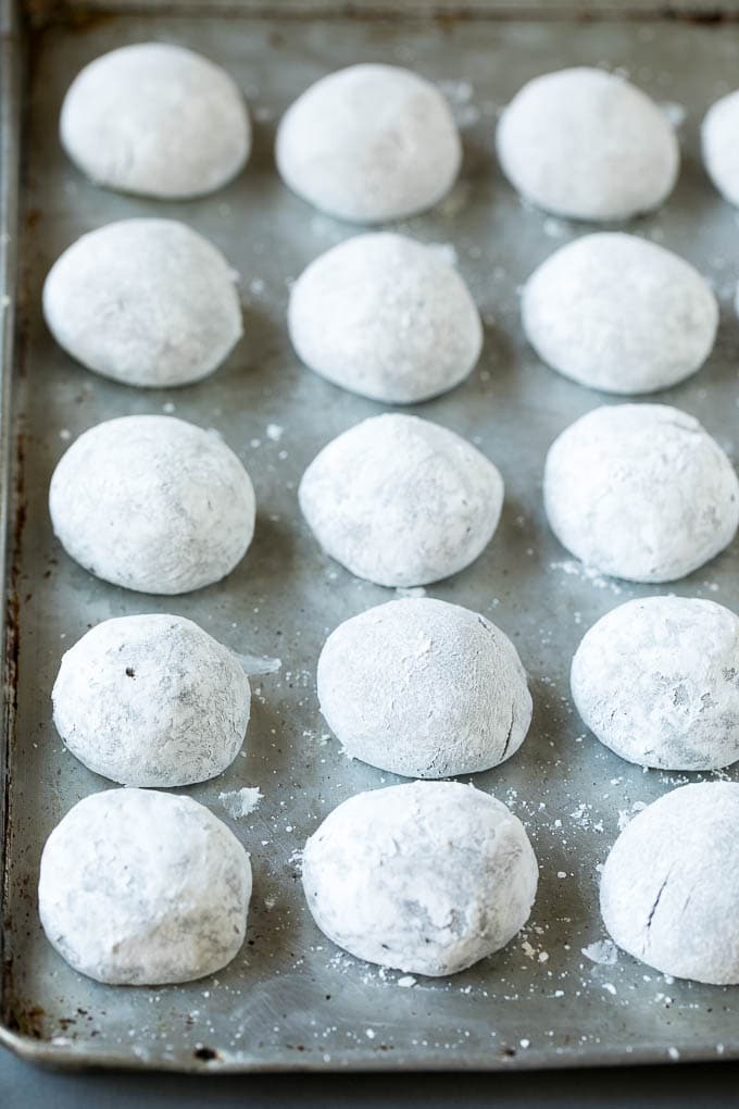 Balls of cookie dough rolled in powdered sugar.
