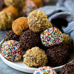 Chocolate truffles coated in nuts, sprinkles and cocoa powder.