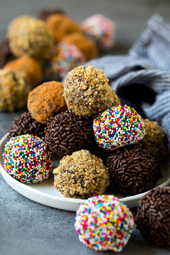 Chocolate truffles coated in nuts, sprinkles and cocoa powder.