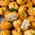 A sheet pan of fried mushrooms garnished with parsley.