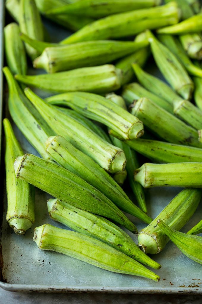 Okra pods on a sheet pan.