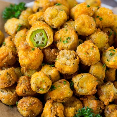 A serving plate of fried okra garnished with parsley.
