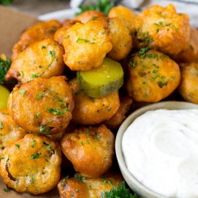 A plate of fried pickles, served with ranch dip.