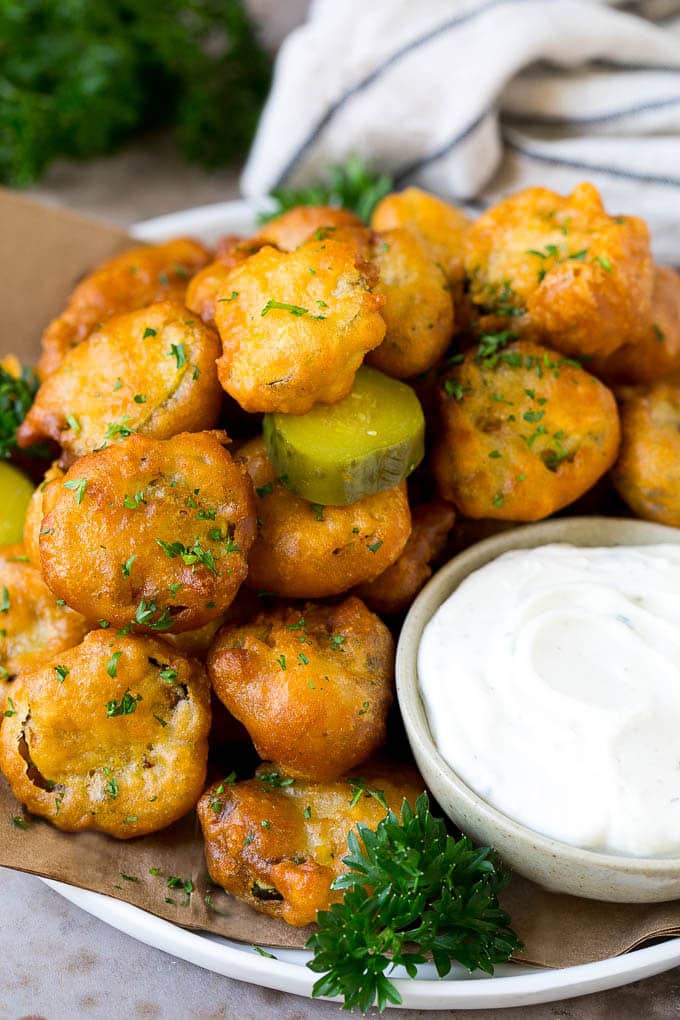 A plate of fried pickles, served with ranch dip.