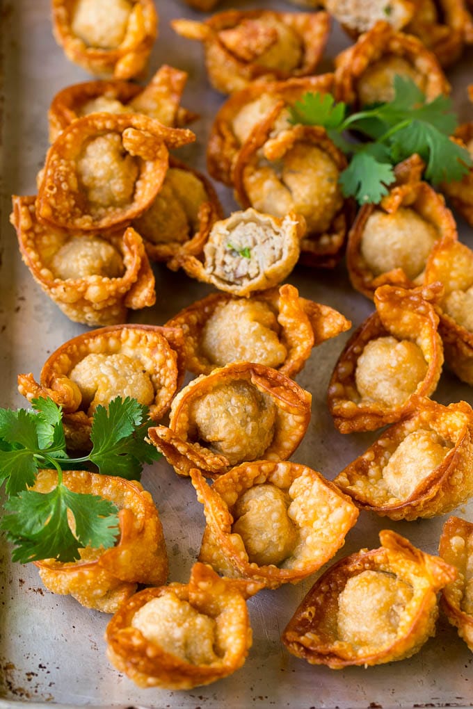 Fried wonton on a sheet pan, garnished with cilantro.