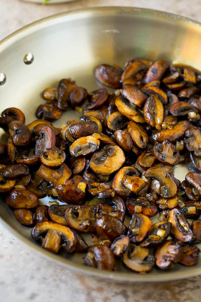 Sauteed cremini mushrooms in a pan.