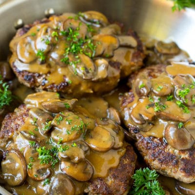 Hamburger steak topped with mushroom gravy and chopped parsley.