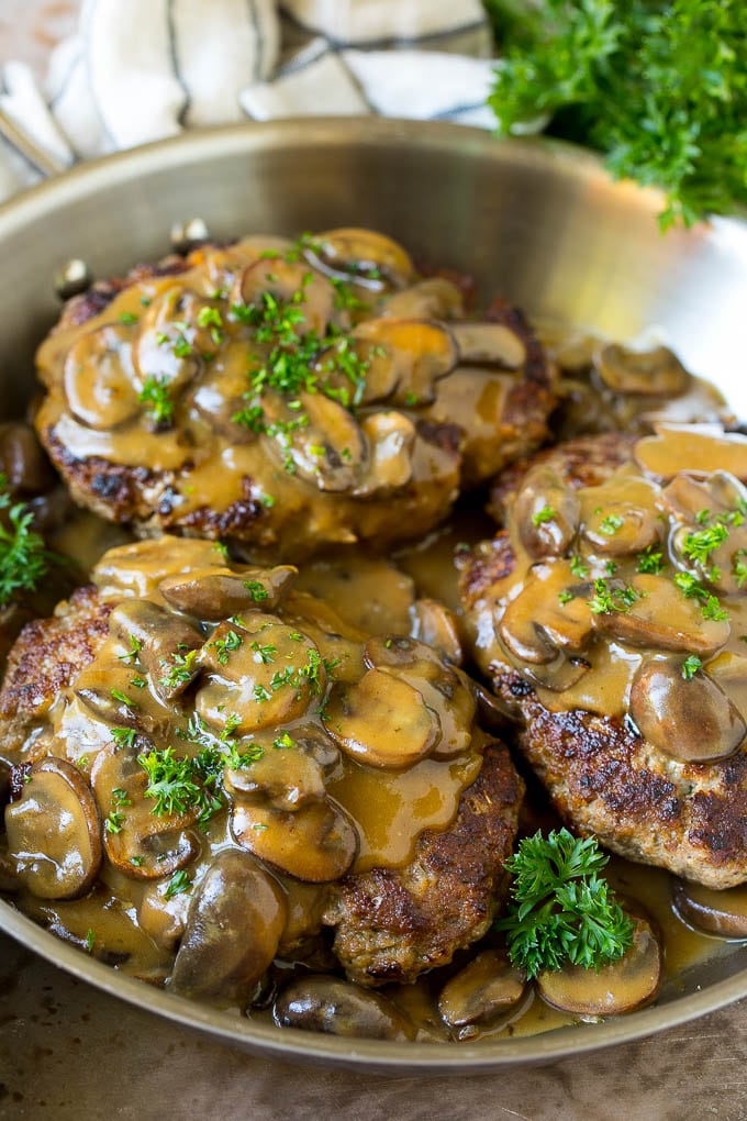 Hamburger steak topped with mushroom gravy and chopped parsley.