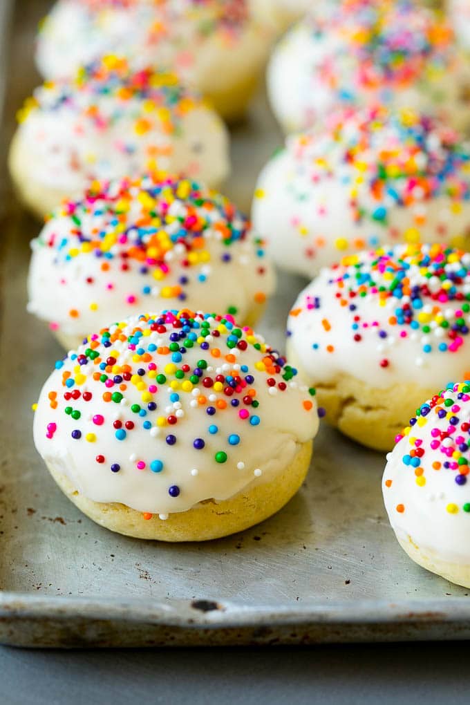 Italian cookies covered in frosting and rainbow sprinkles.