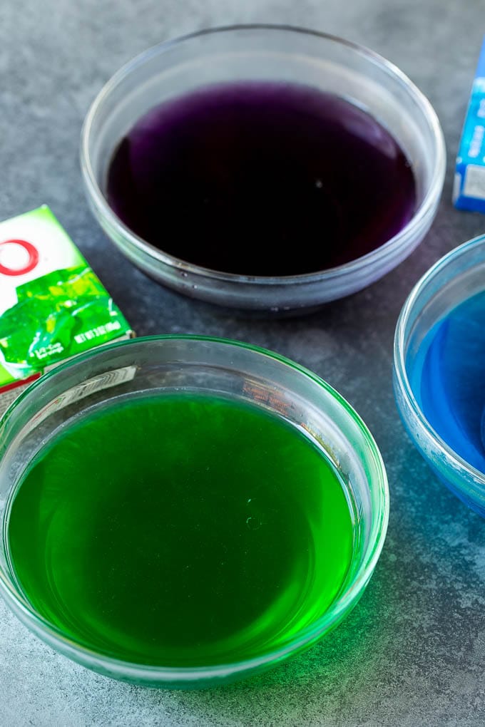 Bowls of liquid gelatin in different colors.