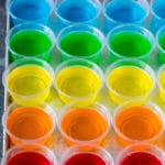 All different colored Jello shots on a sheet pan.