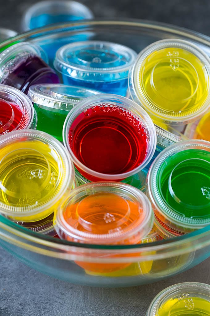 A bowl of jello shots packed in plastic containers.