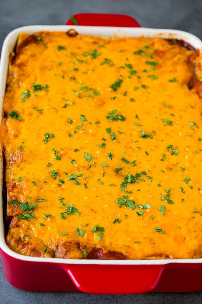 A baked Mexican casserole topped with melted cheese and cilantro.