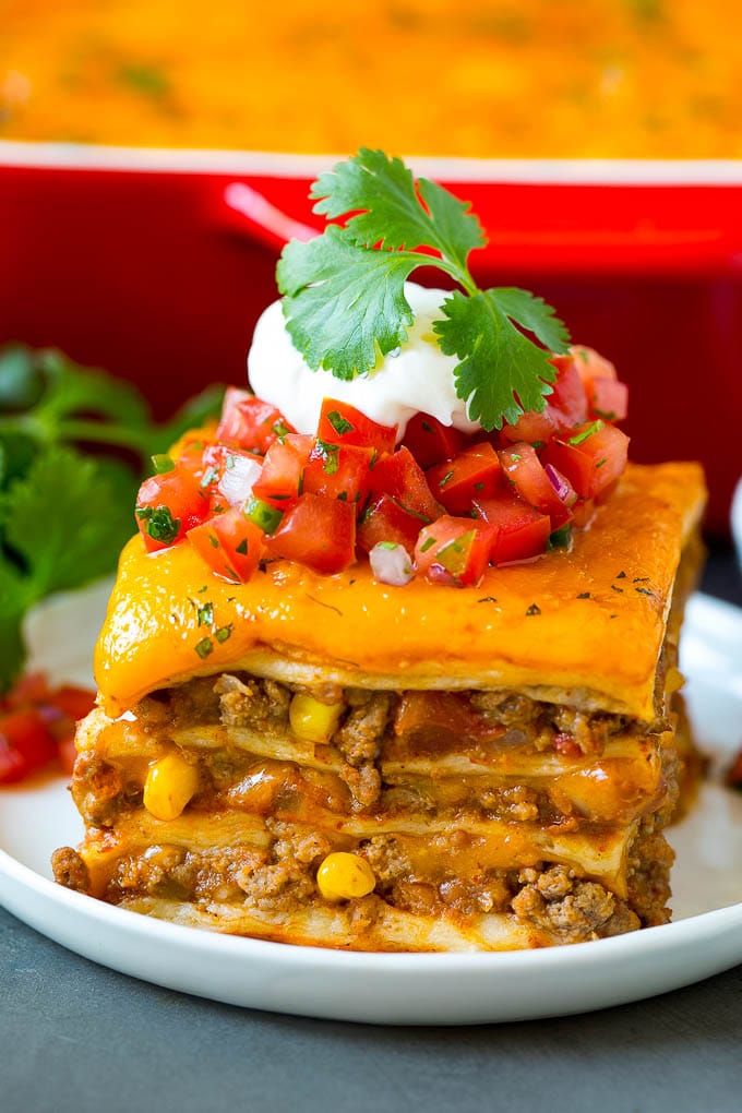 A slice of Mexican lasagna made with layers of cheese, tortillas and meat.